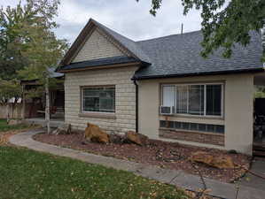 View of side of property featuring roof with shingles