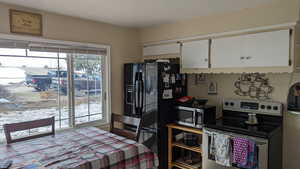 Kitchen featuring stainless steel appliances and white cabinetry