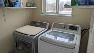 Clothes washing area featuring washing machine and clothes dryer