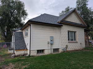 View of home's exterior with a shingled roof