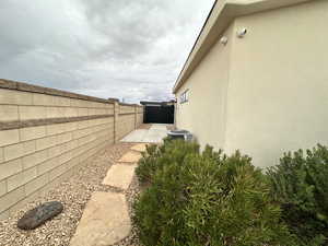 Fenced backyard featuring central air condition unit