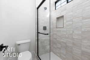Bathroom with a stall shower and toilet