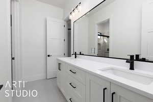 Bathroom with a stall shower, double vanity, tile patterned flooring, and baseboards