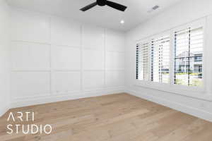 Empty room with a ceiling fan, a decorative wall, light wood-style flooring, baseboards, and recessed lighting