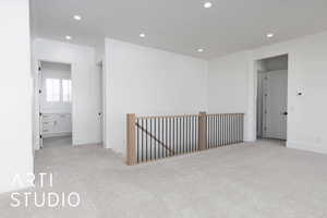Empty room with light carpet, recessed lighting, and baseboards