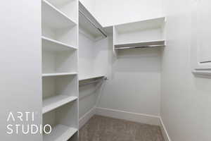 Walk in closet featuring carpet flooring