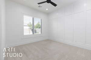Spare room featuring carpet, a decorative wall, ceiling fan, baseboards, and recessed lighting