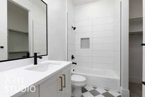 Bathroom with toilet, vanity, and shower / bath combination