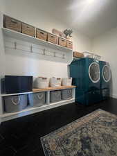 Mudroom with washing machine and clothes dryer and tile patterned floors