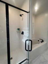 Full bathroom featuring a shower stall and a garden tub
