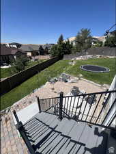 View of patio featuring a trampoline and a residential view