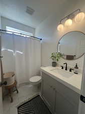 Bathroom featuring vanity, toilet, marble finish flooring, and a shower with shower curtain