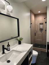Bathroom with a shower stall, recessed lighting, toilet, tile patterned flooring, and vanity