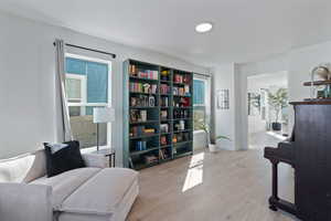 Sitting room featuring light wood-style flooring and baseboards