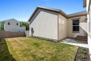View of home's exterior with stucco siding and a patio