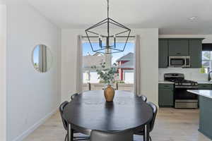 Dining room featuring a chandelier and light wood-style floors