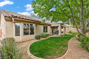 Back of house with stucco siding, a patio, and a tile roof