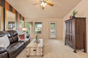 Living area with ceiling fan, light colored carpet, and baseboards
