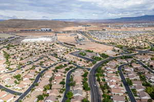 Aerial overview of property's location with mountains and nearby suburban area