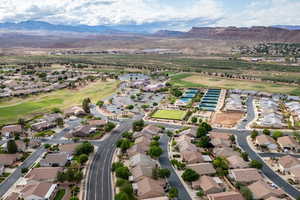 Aerial view of property's location with mountains, nearby suburban area, and a local golf course