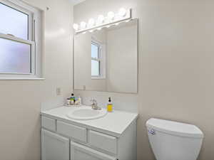 Bathroom featuring vanity and toilet