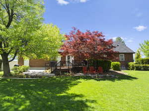 View of green lawn with a patio