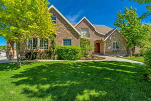 View of front of home featuring brick siding and a front lawn