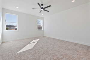 Carpeted spare room with baseboards, recessed lighting, and a ceiling fan