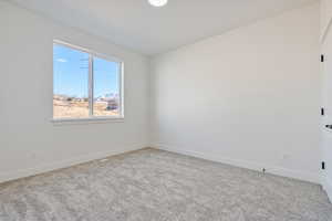 Spare room with carpet floors and baseboards
