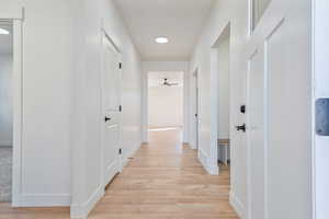 Hall featuring light wood-style flooring and baseboards