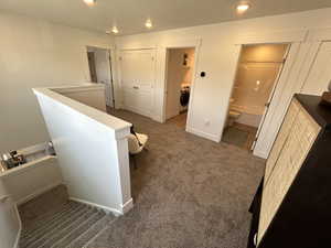 Hall with carpet, washer / dryer, recessed lighting, and baseboards