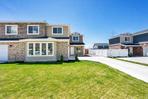 View of front of house featuring driveway and brick siding