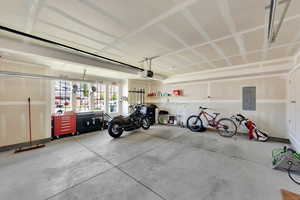 Garage featuring electric panel and a garage door opener