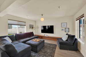 Living area with plenty of natural light, light wood-type flooring, and baseboards