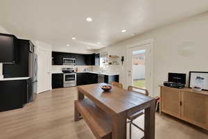 Dining room featuring light wood finished floors and recessed lighting