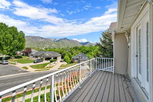 Balcony featuring a mountain view and a residential view