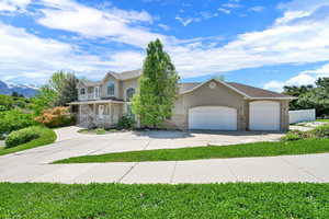 View of front of house featuring driveway, a garage, stucco siding, and a porch