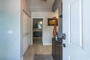 Entrance foyer featuring light tile patterned floors and baseboards