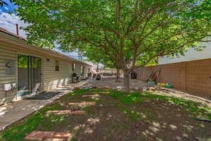 Fenced backyard with a patio