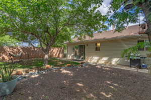 Back of house with fence and a tiled roof