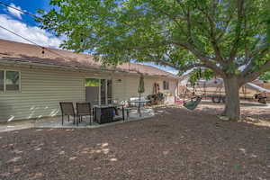 Back of house featuring a patio and a tiled roof