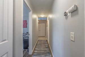 Corridor featuring baseboards