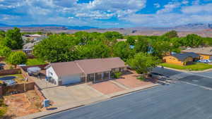 Aerial view of property and surrounding area with a mountain backdrop