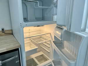 Kitchen view of refrigerator and light countertops