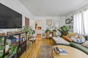 Living room featuring light wood finished floors and recessed lighting