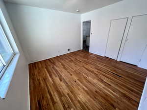 Unfurnished bedroom with hardwood / wood-style floors
