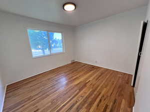 Unfurnished room with wood finished floors