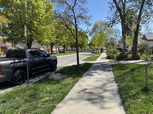 View of asphalt street featuring sidewalks