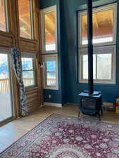 Entryway featuring a wood stove and plenty of natural light