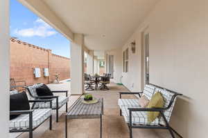 View of patio with fence, outdoor dining space, and an outdoor hangout area